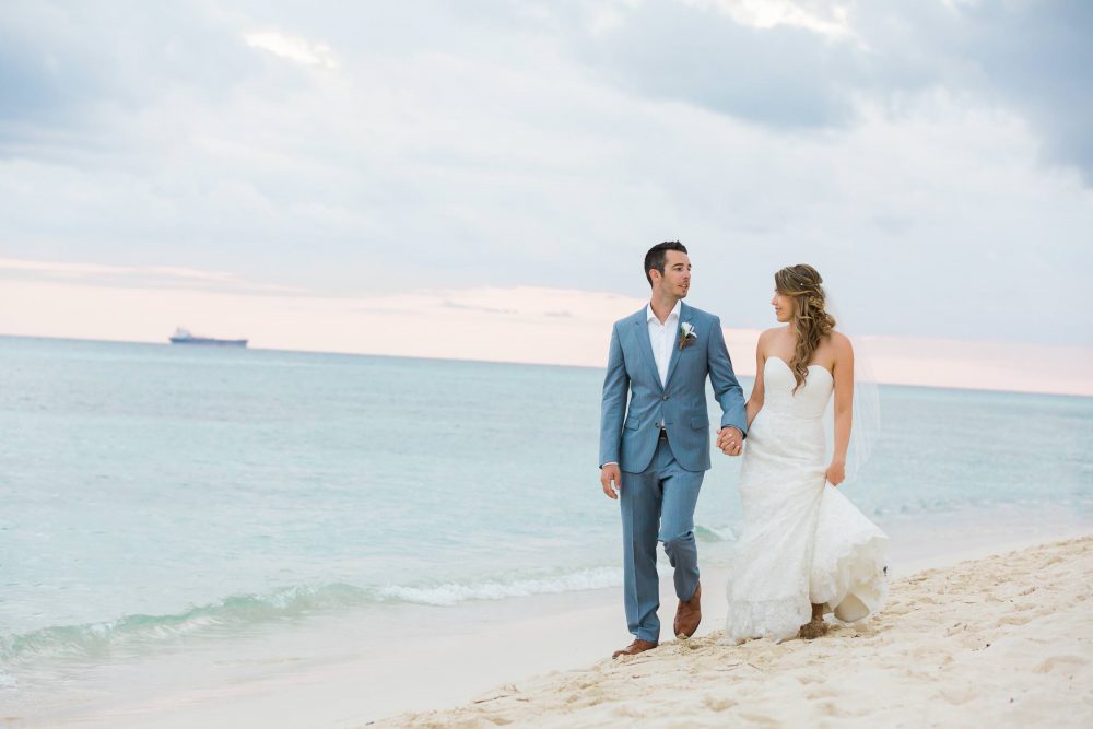Bride and groom walking on the beach photo in Mexico | Vancouver wedding photographer