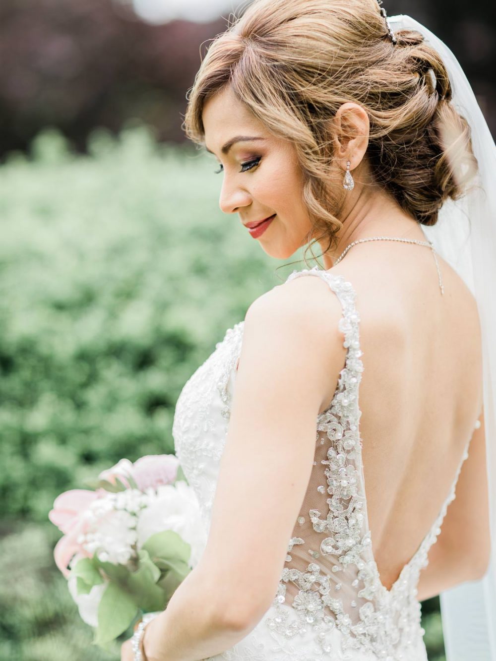 Bride posing with flowers | Vancouver wedding photographer
