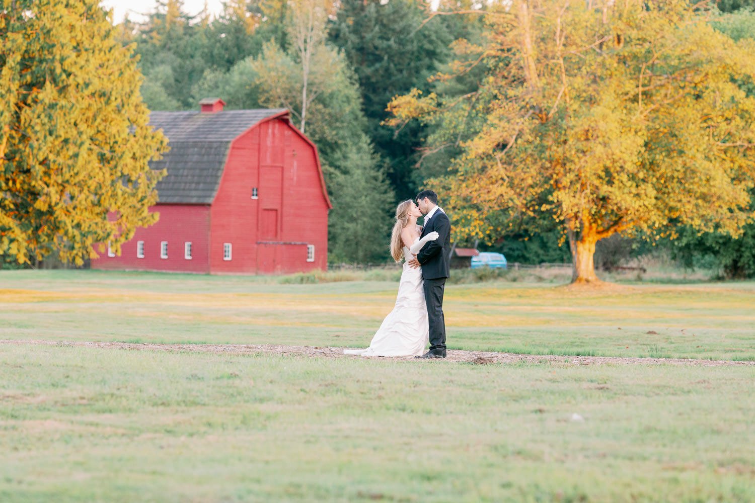 Couple posing in the Campbell Valley park with barn at the back by wedding photographer