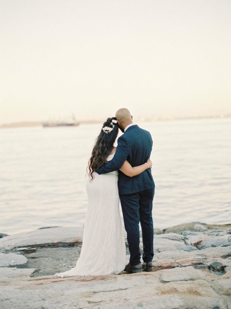 A wedding couple hugging standing on the cliff | Wedding Photographer in Vancouver